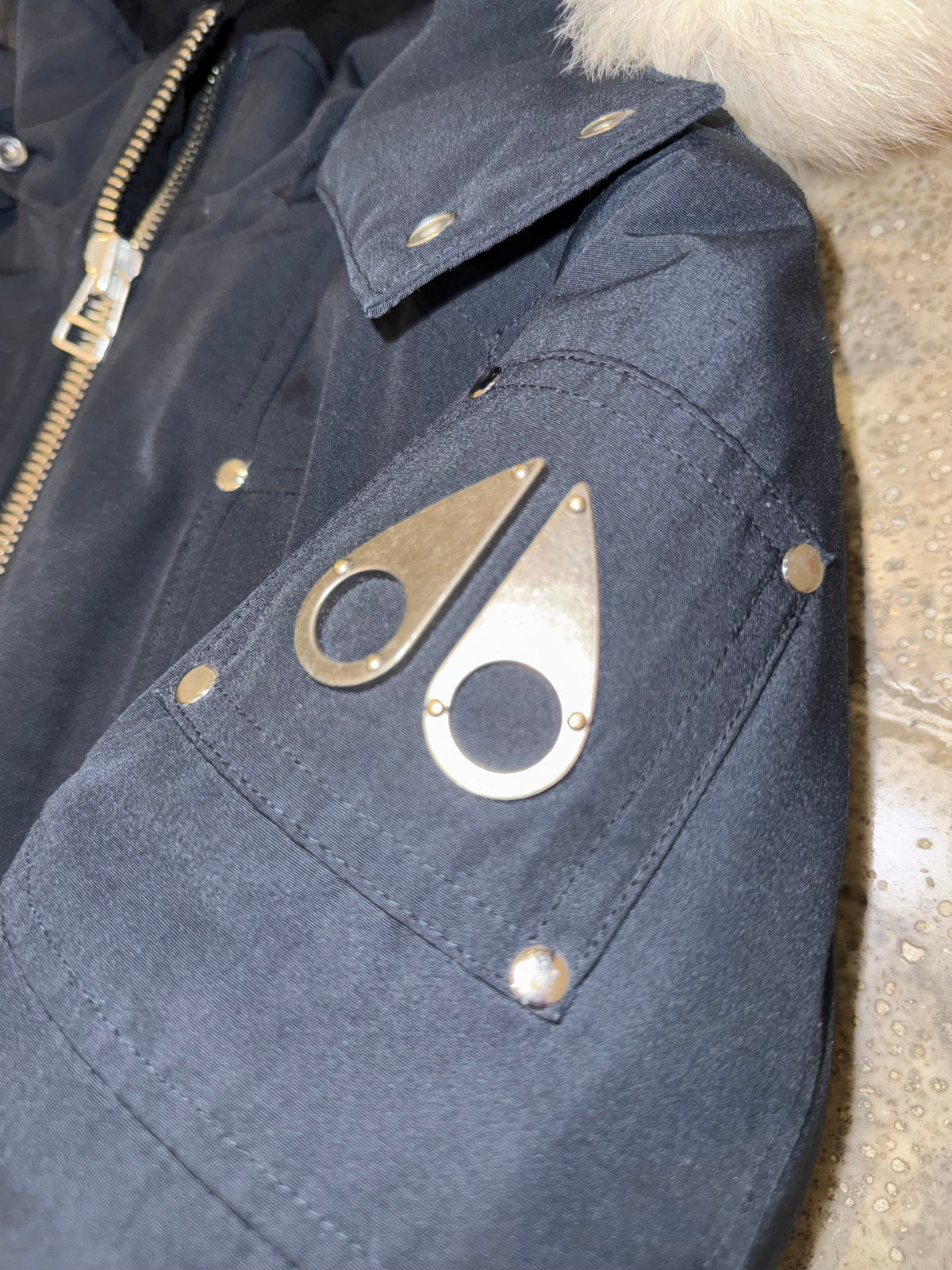 Moose Knuckles Steel Blue Down Bomber Jacket with White Fur Hood and Black Ribbed Trim