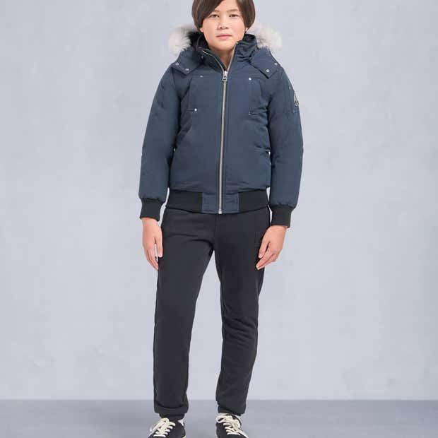 Moose Knuckles Steel Blue Down Bomber Jacket with White Fur Hood and Black Ribbed Trim